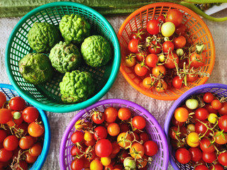 Sets of Red Berries and Fresh Green Kaffir Limes in Baskets for Sale