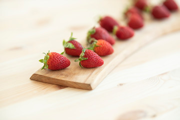 red fresh strawberries on wooden table