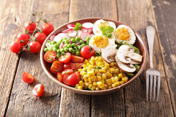 vegetable salad bowl with tomato, egg, corn, radish and pea
