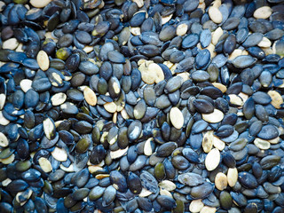 Peeled oval dark pumpkin seeds macro . Food preparation . Texture