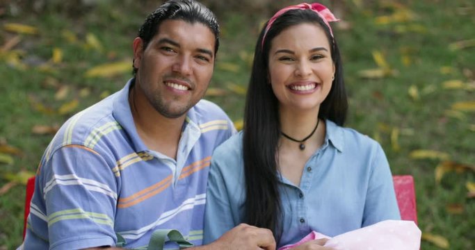 Portrait Young Hispanic Couple With Newborn Baby at The Park
