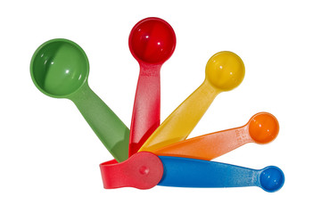 A multicolored set of plastic measuring spoons, ranging from 1 tablespoon to 1/4 teaspoon. Isolated on white