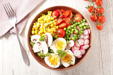 vegetable salad bowl with tomato, egg, corn, radish and pea
