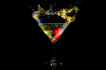 cocktail with strawberry splash in blue and yellow