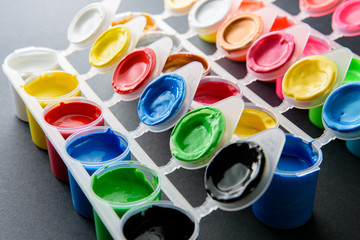 Palette of ready mix poster paint in small cans