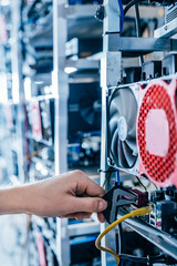 IT engineer fixing computer server on bitcoin and crypto currency mining farm