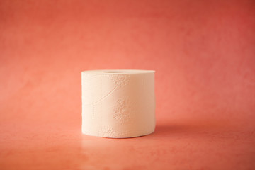 Soft, white toilet paper roll on pink pastel bright background. Hygiene concept. Empty place for text, object or logo.