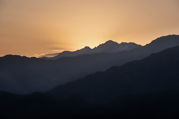 Mountains are lit by the setting sun in the Tusheti region.