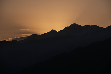 Mountains are lit by the setting sun in the Tusheti region.