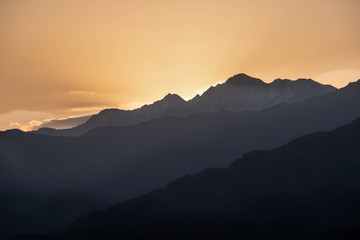 Mountains are lit by the setting sun in the Tusheti region.