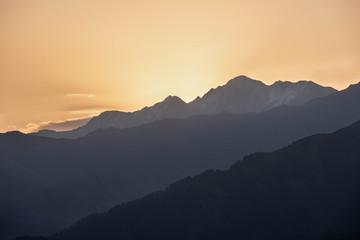 Mountains are lit by the setting sun in the Tusheti region.