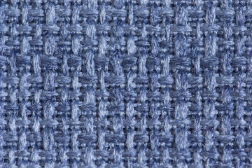 Abstract background from upholstery fabric guns for furniture in a large knit of blue threads in macro, empty template. Gunny. Large weaving of threads on the fabric.