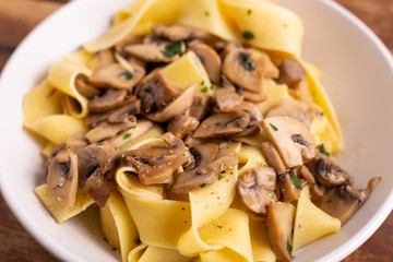 Homemade mushroom tagliatelle. Typical dish of the Italian tradition. Idea for a quick and nutritious lunch.
