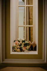 wedding bouquet and shoes on the window
