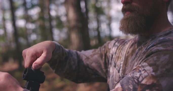 Man hunting in woods with rifle