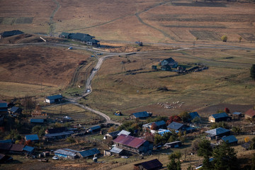 Landscape view of lower Omala in Tusheti with a herd of sheep walking on the right.