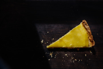 Details von einem Stück Französische Zitronentarte, Zitronenkuchen mit Zitrone und Mürbeteig,...