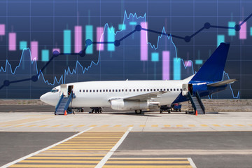 Fluctuating graphics near the plane. Concept - an increase in the riskiness of investments air. A growing chart as a symbol of increased risk. Falling shares of air carriers. Aircraft Production