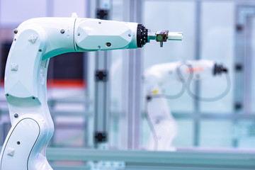White robotic arm. Robotic complex in a glass chamber. Robot manipulator in the enterprise. Manipulator with remote control. High tech. Concept - sale of industrial robots.