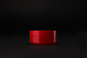 cosmetic jar without a label. Cosmetic packaging, empty red jar branding mockup isolated on black background