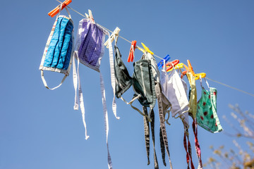 Washed makeshift fabric face masks are drying on a clothes line