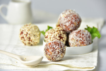 Middle Eastern, ball-shaped dessert made of dried apricots with various coatings. Energy balls. Salad leaves.