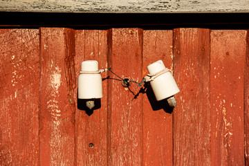 Electric insulators on a barn wall.