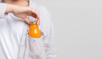 Woman getting out of pocket small glass bottle for refilling energy balance