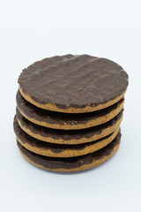 Five Digestive Biscuits piled on top of each other on a white background.