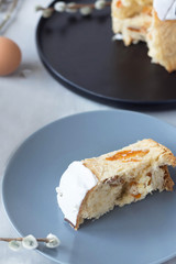 slice of sweet bread with white icing, dried apricots and nuts on a plate, baking, Easter cake, easter, view from above