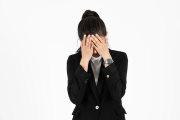 Tired overworked Asian business woman with hands on face suffering from severe depression on white isolated background. Unemployment and layoff concept.