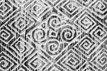 Black and white textured hand-carved wooden background. The spiral patterns. Folk art of the inhabitants of Bali.