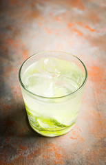 Rum based cocktail caipirinha (variation of cuba libre) on the rustic background. Selective focus. Shallow depth of field.
