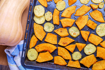Pumpkin and potatoes on a baking tray