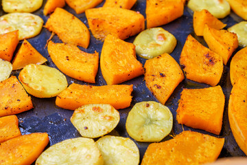 Pumpkin and potatoes on a baking tray