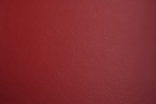 Red leatherette. Burgundy faux leather. Leather texture. Dark red background