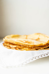 pancakes on a white tablecloth and plate a sunny day with sun glare