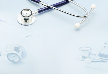 Double exposure on stethoscope for doctor checkup on light blue background with copy space, healthcare and medical concept.