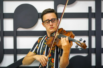 Young musician playing the violin, Close Up, Playing his handmade violin with great success
