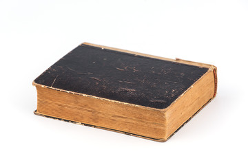 Old shabby and worn book on clean white background