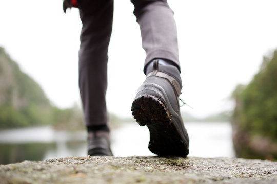 person walking with hiking boots outdoors