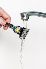 shaving razor under pouring water on a white background