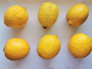 Lemons. 6 whole lemons on a white background. Top view. Fresh vitamin nutrition. Natural food. Isolated citrus fruit set.
