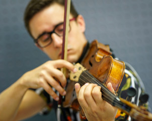 Musician playing violin with Pizzicato technique, close up