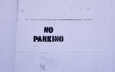 "no parking" sign on a white background, on a white wall
