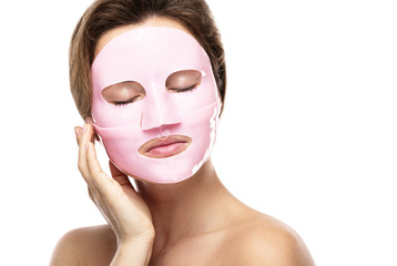 Young beautiful woman with rubber facial mask on her face