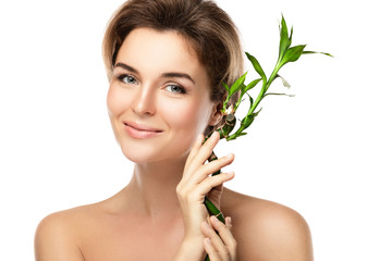 Young beautiful woman with a green bamboo branch