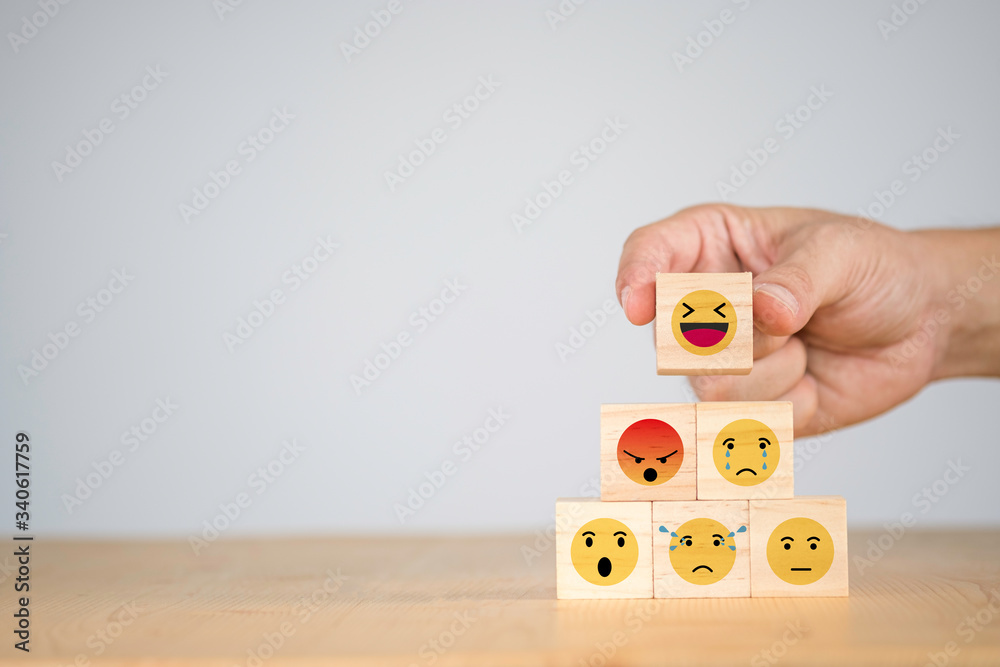 Aufkleber customer hand putting happy and smile face emotion which print screen on wooden block on sad emotion