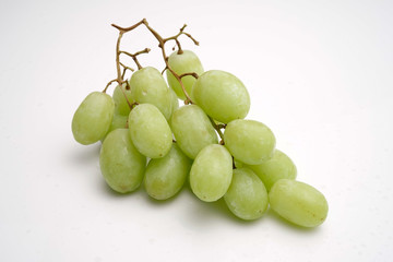 Fresh green seedless grapes on white. stock photo