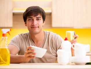 Man washing dishes at home